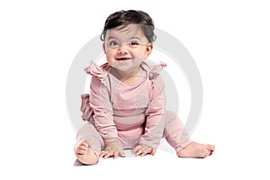 Smiling baby posing on studio floor.