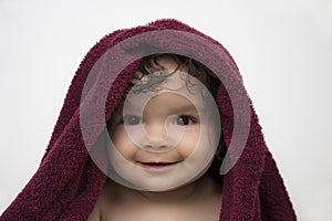 Smiling baby in red bath towel