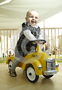 Smiling Baby Riding Toy Car