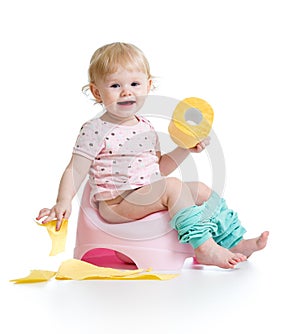 Smiling baby sitting on chamber pot