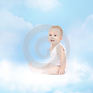 Smiling baby sitting on the cloud