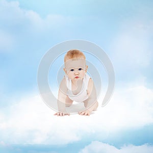 Smiling baby sitting on the cloud