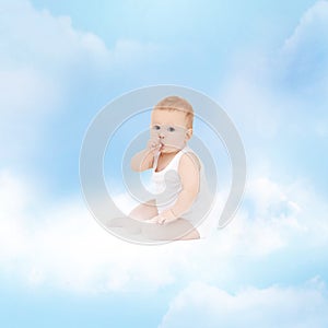 Smiling baby sitting on the cloud