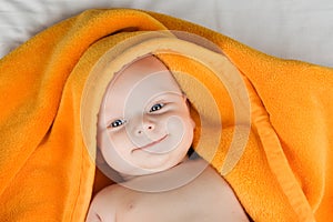 Smiling baby under towel