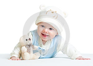 Smiling baby weared hat with plush toy photo