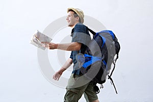 Smiling backpacker with map walking