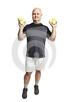 A smiling bald man in a sports uniform with tennis balls in his hands is smiling. Full height. Isolated over white background.