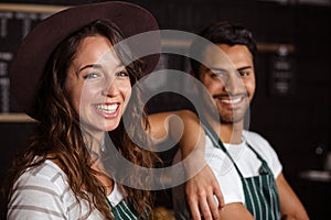 Smiling baristas looking at the camera