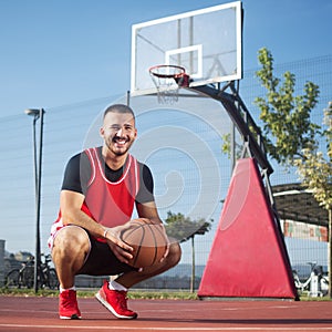 Smiling basketball player on playground