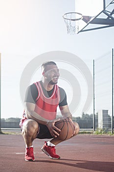 Smiling basketball player on playground