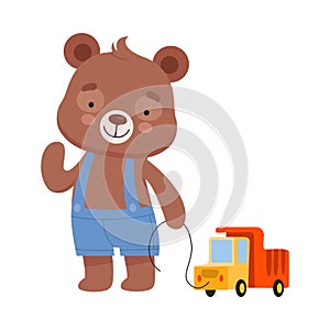 Smiling Bear Character Wearing Playsuit Pulling Toy Truck by the Rope Vector Illustration photo