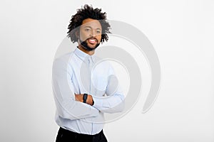 Smiling bearded african-american businessman standing with arms crossed and looking at the camera. Proud and successful