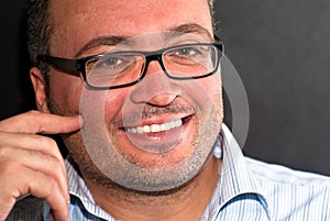 Smiling bearded caucasian man wearing eyeglasses striped shirt