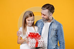 Smiling bearded man have fun with child baby girl. Father little kid daughter isolated on yellow background. Love family