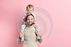 Smiling bearded man and his son playing indoors