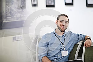 Smiling Bearded Man in Museum