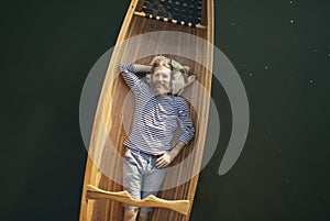 Smiling bearded man relaxing in the canoe