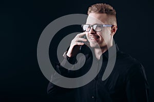 Smiling Bearded Youngster in Glasses Talking on Smartphone