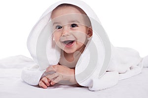 Smiling beautiful baby child with white towel