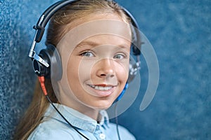 Smiling beautiful female patient in headphones looking ahead photo