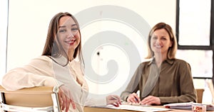 Smiling beautiful female student after successful job interview in office