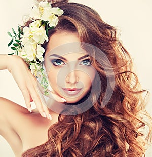 Smiling Beautiful girl.Delicate pastel flowers in curly hair