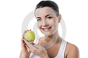 smiling beautiful girl holding ripe apple