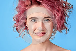 Smiling beautiful girl with nose piercing and colored pink hair