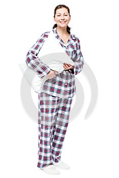 Smiling beautiful girl in pajamas and slippers hugging