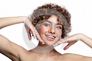 Smiling beautiful freckled girl with curly hair