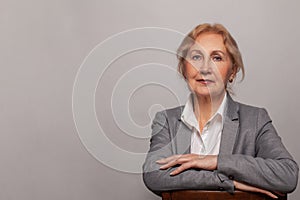 Smiling beautiful mature business woman on white background. Older senior businesswoman, 60s lady professional female ceo