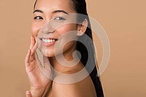 Smiling beautiful naked asian girl looking