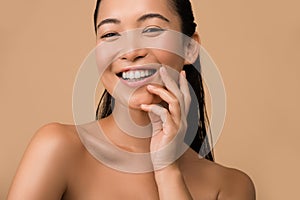 Smiling beautiful naked asian girl touching