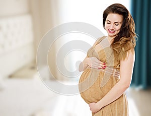 Smiling beautiful pregnant woman at home with big belly. Pregnancy and motherhood concept. Happy baby expectation. Interior space