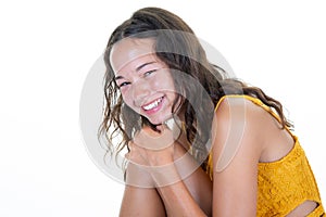 Smiling beautiful slim brunette young girl in casual clothes expressing happy emotions teenager in white background