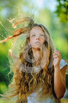 Smiling beautiful teenage wind with flying hair