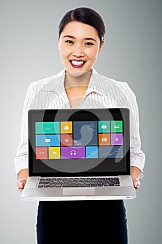 Smiling beautiful woman holding laptop