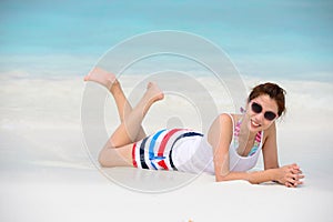 Smiling beautiful woman lie on the beach lie on the beach