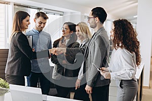 Smiling beautiful woman shaking male hand, greeting handshake of female applicant arriving at job interview, businesswoman making