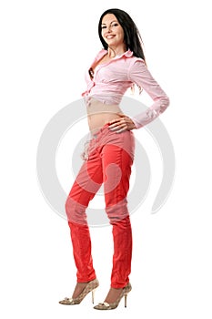 Smiling beautiful young brunette in red jeans