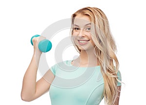Smiling beautiful young sporty woman with dumbbell