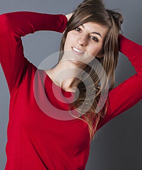 Smiling beautiful young woman playing with her hair for sensuality