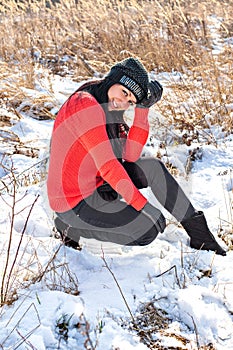 Smiling beautiful young woman relaxing outdoor in a winter day