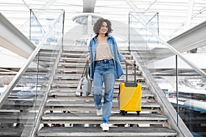 Smiling Beautiful Young Woman Walking With Suitcases On Stairs At Airport