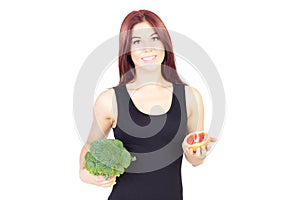 Smiling beauty woman holding grapefruit and broccoli. Woman sitting on a diet. Vegan food.