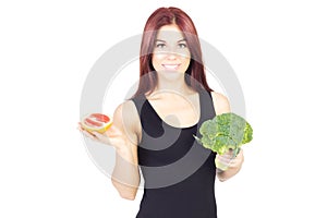 Smiling beauty woman showing grapefruit and broccoli. Woman sitting on a diet. Vegan food.