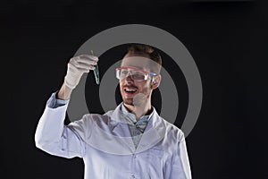 Smiling biologist holding test tube with plant