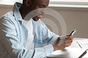 Smiling biracial man have pleasant chat on cellphone