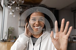 Smiling biracial woman wave at camera talking on video call