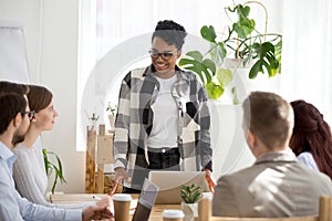 Smiling black businesswoman lead casual office meeting